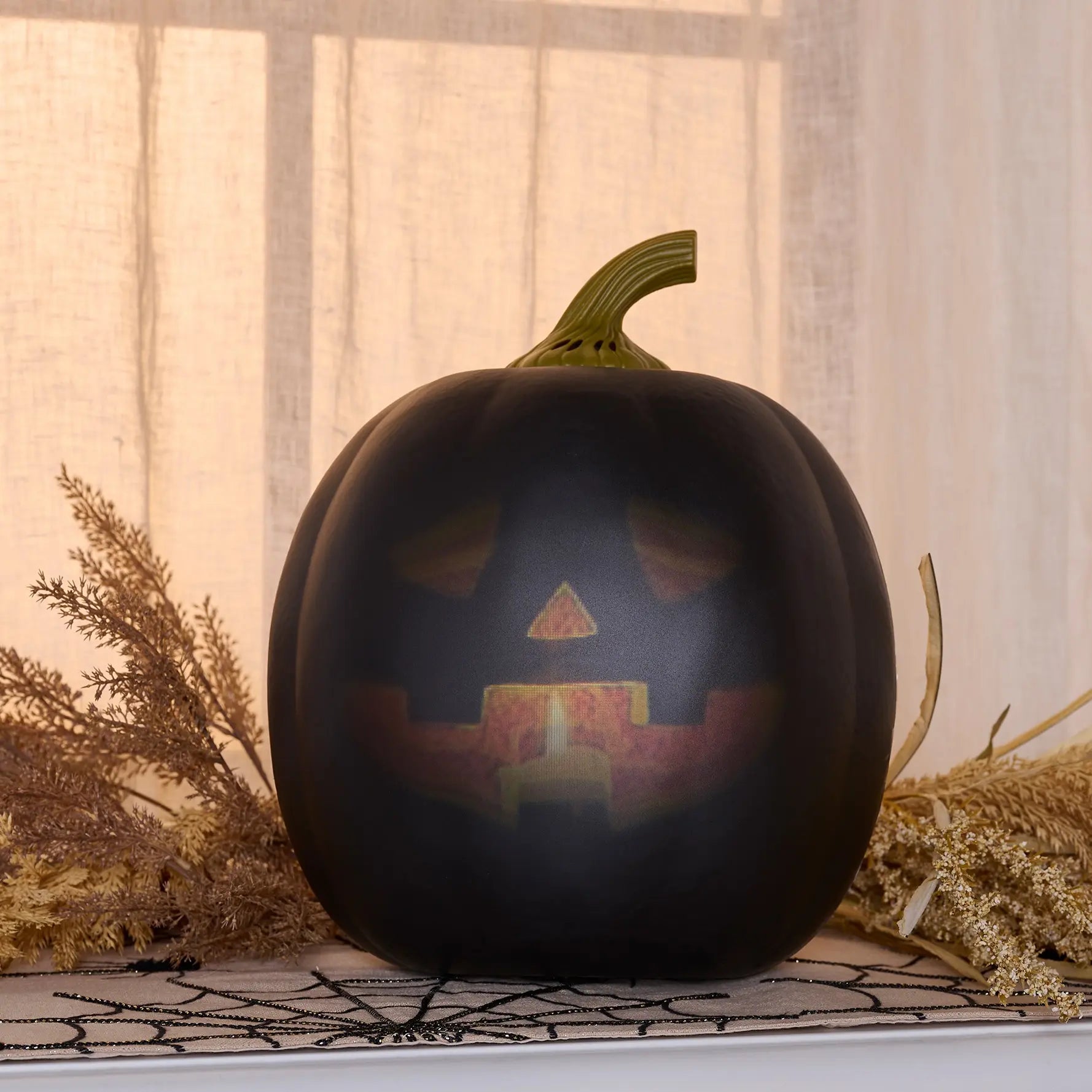Lumenjack Animated Talking Pumpkin in Black styled on a mantel